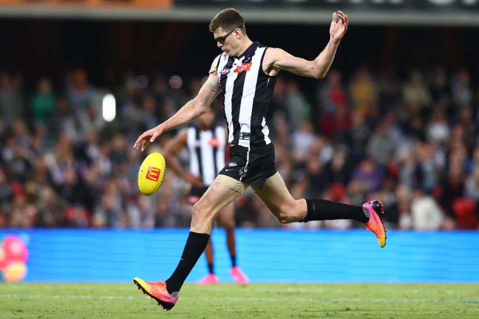 The Collingwood Magpies' Mason Cox kicks the ball during a match against Gold Coast Suns at Heritage Bank Stadium
