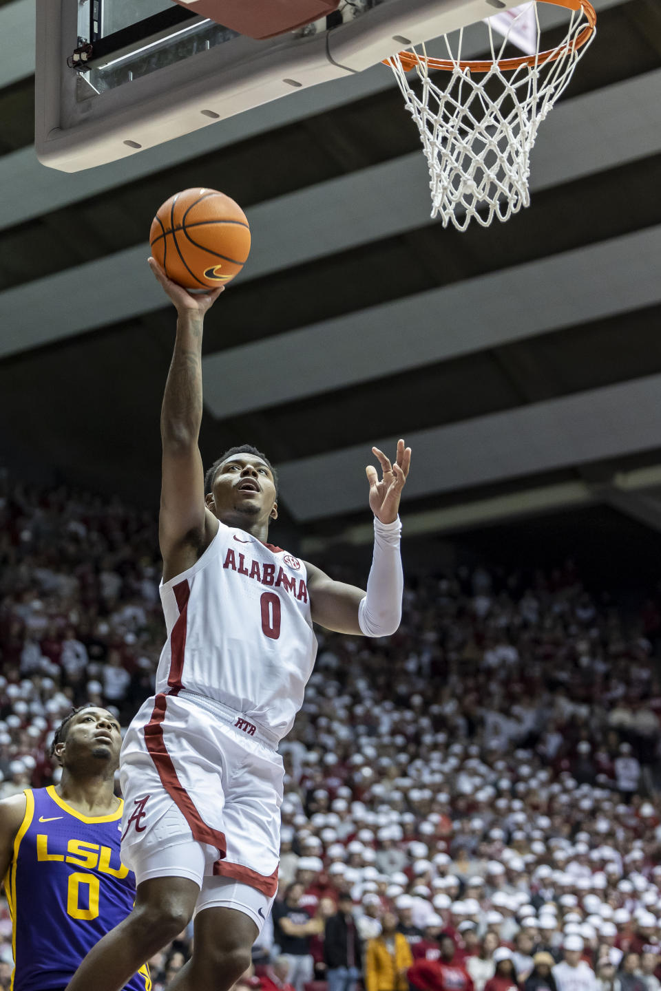 Alabama guard Jaden Bradley, right, shoots from close range on a fast break as LSU guard Trae Hannibal, left, watches during the second half of an NCAA college basketball game, Saturday, Jan. 14, 2023, in Tuscaloosa, Ala. (AP Photo/Vasha Hunt)