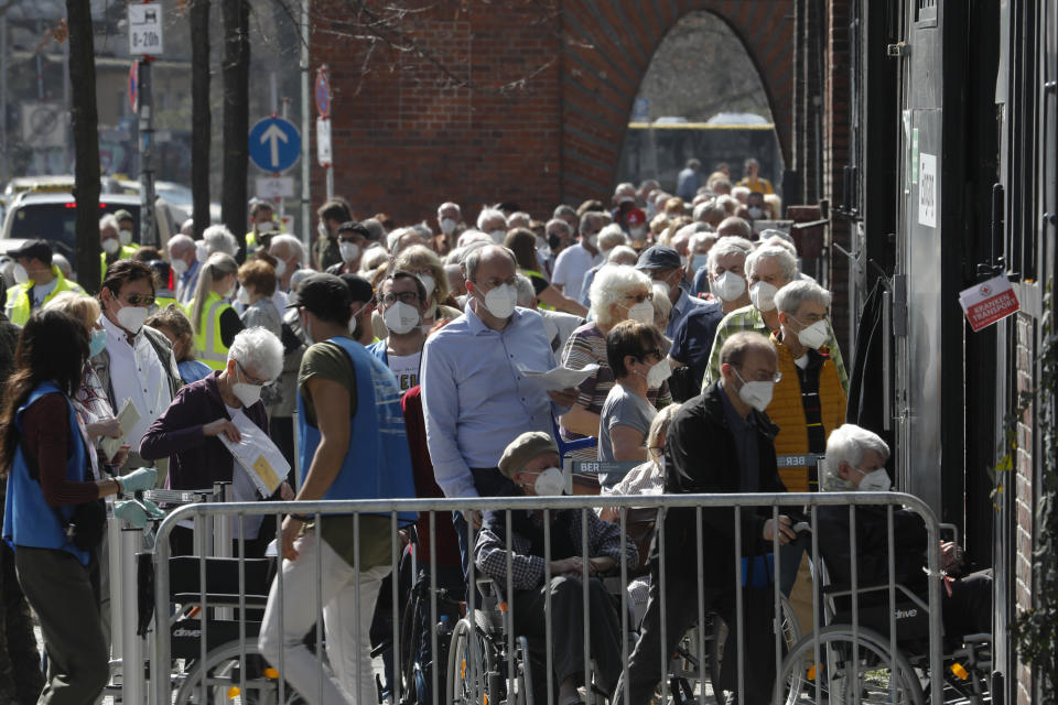 File- In this Wednesday, March 31, 2021 file photo, people line up in front of the vaccination center at the Arena Treptow in Berlin, Germany. Germany's health minister Jens Spahn says today the country has now given a first coronavirus vaccine shot to more than half of its population. (AP Photo/Markus Schreiber, file)