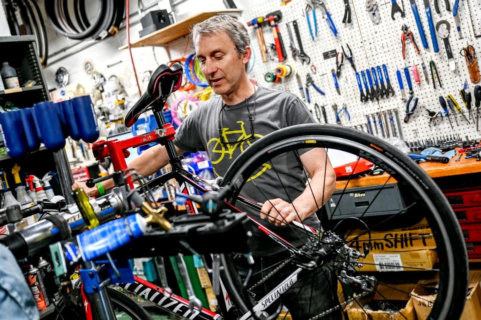 Tim Potter, manager of the MSU Bikes Service Center, works on a bicyclist on Monday, May 9, 2022, at the shop in East Lansing. Potter is one of the organizers for the Greater Lansing 2022 Ride of Silence.