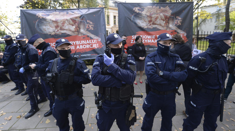 Police guard Poland's constitutional court as pro-choice and anti-abortion activists protest, in Warsaw, Poland, Thursday, Oct. 22, 2020. Poland’s top court has ruled that a law allowing abortion of fetuses with congenital defects is unconstitutional. The decision by the country’s Constitutional Court effectively bans terminating pregnancies in cases where birth defects are found and will further limit access to abortions in Poland. (AP Photo/Czarek Sokolowski)