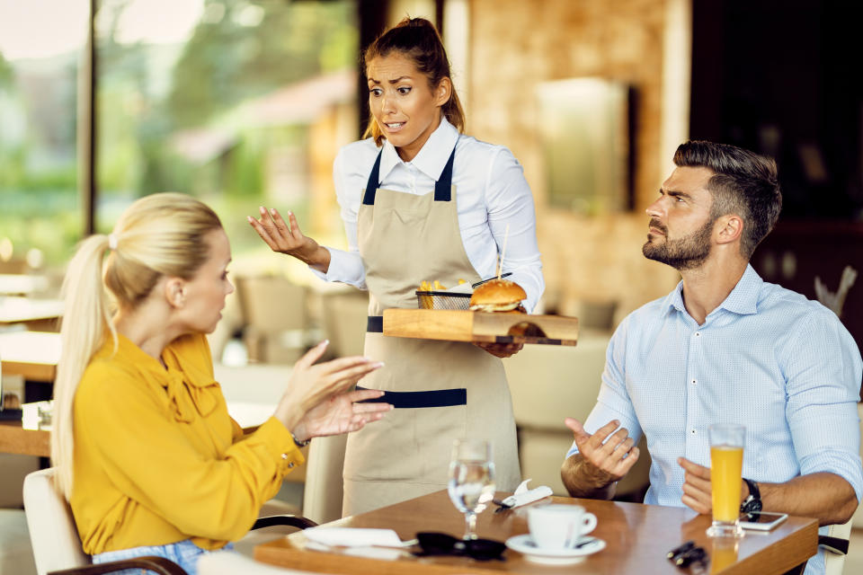 Customers arguing with their waitress