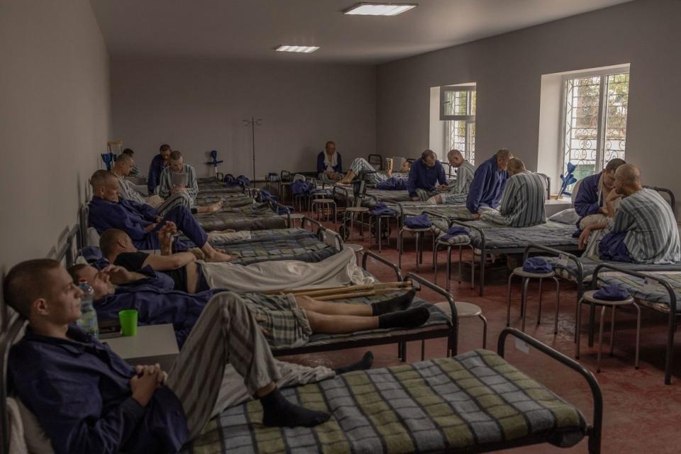 Injured Russian prisoners of war sit and lie on their beds at a camp for Russian POWs in western Ukraine on Sep. 19, 2023, amid the Russian invasion of Ukraine. The center is the last stop for detainees first held in other cities before being exchanged. Ukrainian officials gave a tour of the camp which opened in 2022 for Russian prisoners of war to journalists. (Roman Pilipey/AFP via Getty Images)