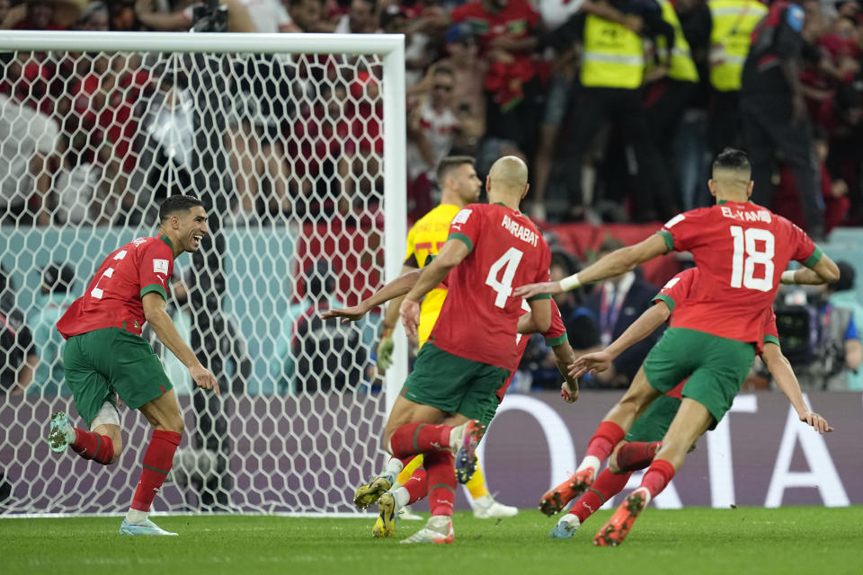 Morocco's Achraf Hakimi, left, celebrates with teammates after scoring the winning penalty in a shootout at the end of the World Cup round of 16 soccer match between Morocco and Spain, at the Education City Stadium in Al Rayyan, Qatar, Tuesday, Dec. 6, 2022. (AP Photo/Ebrahim Noroozi)