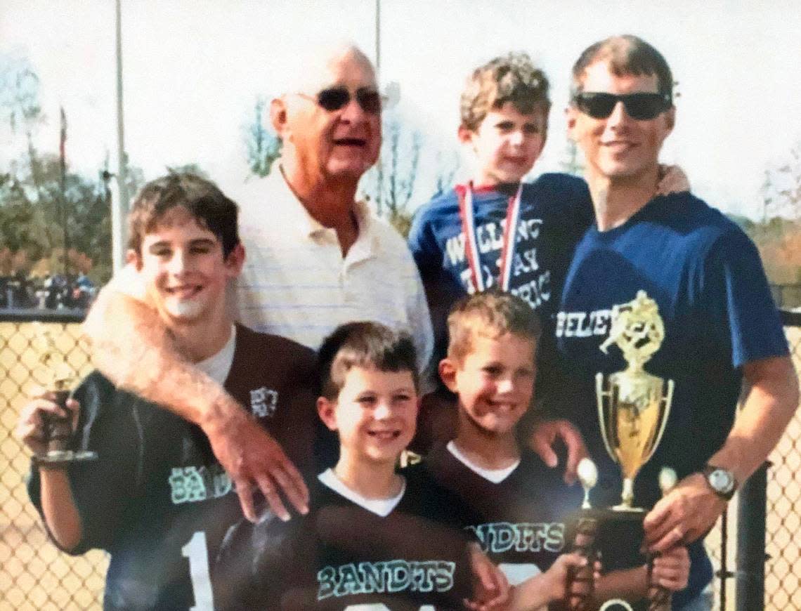 A young Stetson Bennett IV (far left) stands with his grandfather Buddy Bennett, his father, Stetson Bennett III, and brothers Luke, Knox and Maverick after a youth football championship game in Waycross, Georgia.