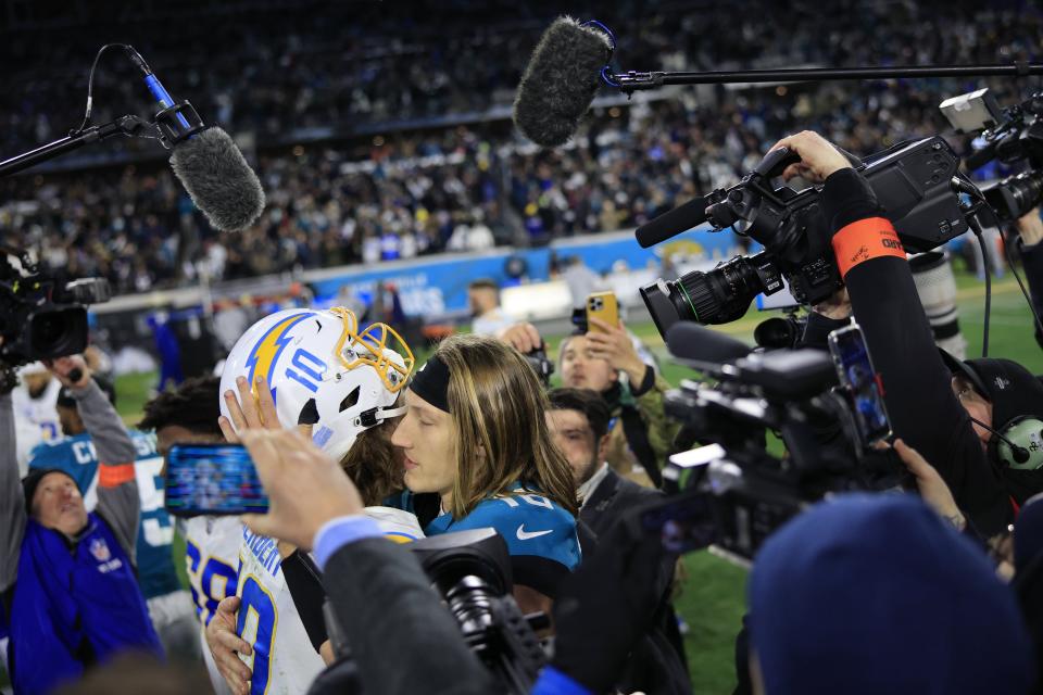 Jaguars quarterback Trevor Lawrence (16) talks with Chargers quarterback Justin Herbert (10) after their playoff matchup in January.