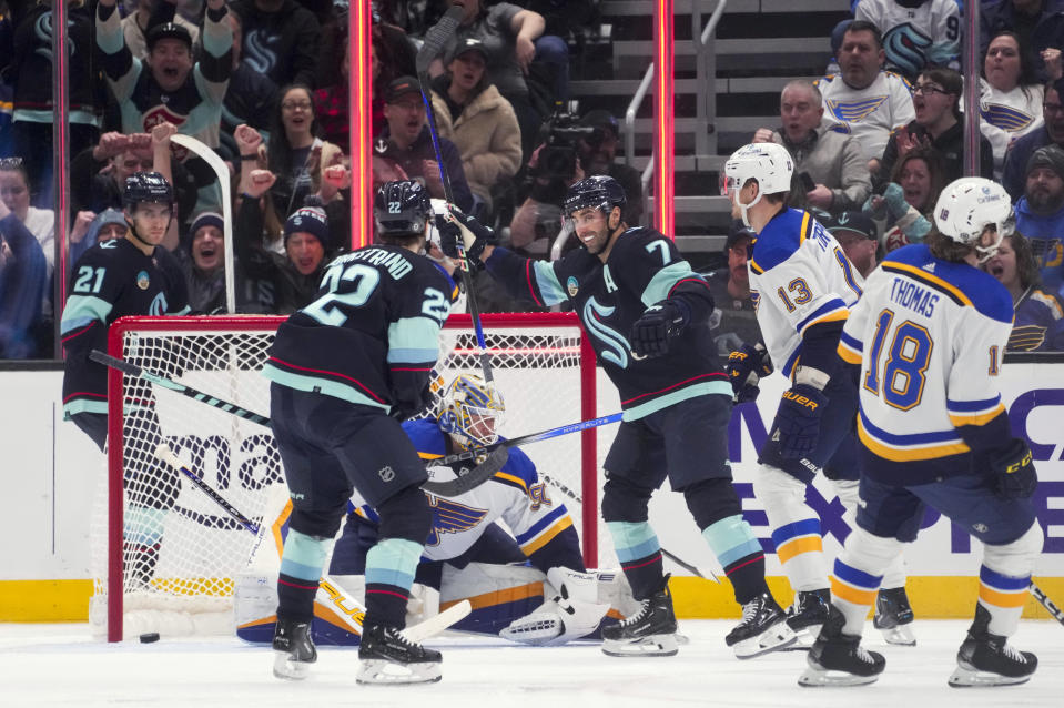 Seattle Kraken right wing Jordan Eberle (7) turns to celebrate the goal by right wing Oliver Bjorkstrand (22) against St. Louis Blues goaltender Jordan Binnington during the second period of an NHL hockey game Friday, Jan. 26, 2024, in Seattle. (AP Photo/Lindsey Wasson)