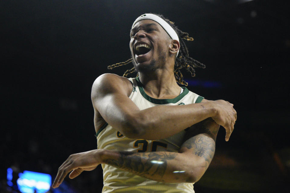 George Mason forward Malik Henry (35) waves to the crowd as he celebrates after the team scores against Dayton during the second half of an NCAA college basketball game, Wednesday, Feb. 21, 2024, in Fairfax, Va. George Mason won 71-67. (AP Photo/Jess Rapfogel)