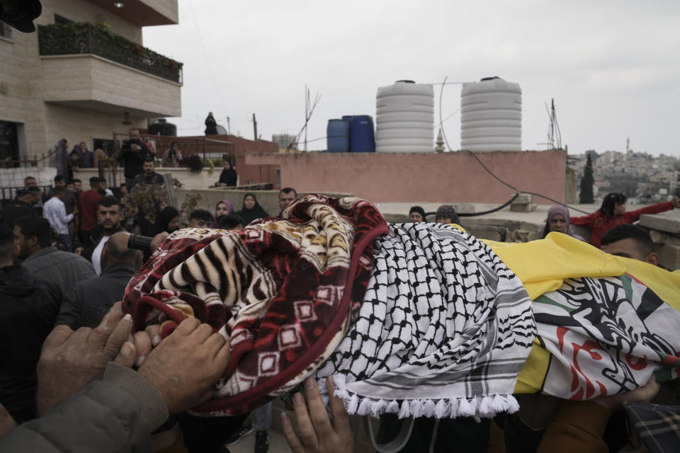 Mourners carry the body of Palestinian Fulla al-Masalmeh,15, during her funeral in the West Bank village of Beit Awwa, Tuesday, Nov. 15, 2022. The Palestinian Health Ministry says Israeli forces shot and killed a 15-year-old Palestinian girl during a pre-dawn raid in the occupied West Bank. The circumstances surrounding the death of the teenage girl in the city of Beitunia in the central West Bank, identified by Palestinian health officials as Fulla al-Masalmeh, were not fully clear. The Israeli military said soldiers opened fire on a vehicle that was accelerating toward them after they signaled for it to stop. The military said it was investigating, and declined to comment further. (AP Photo/Mahmoud Illean)