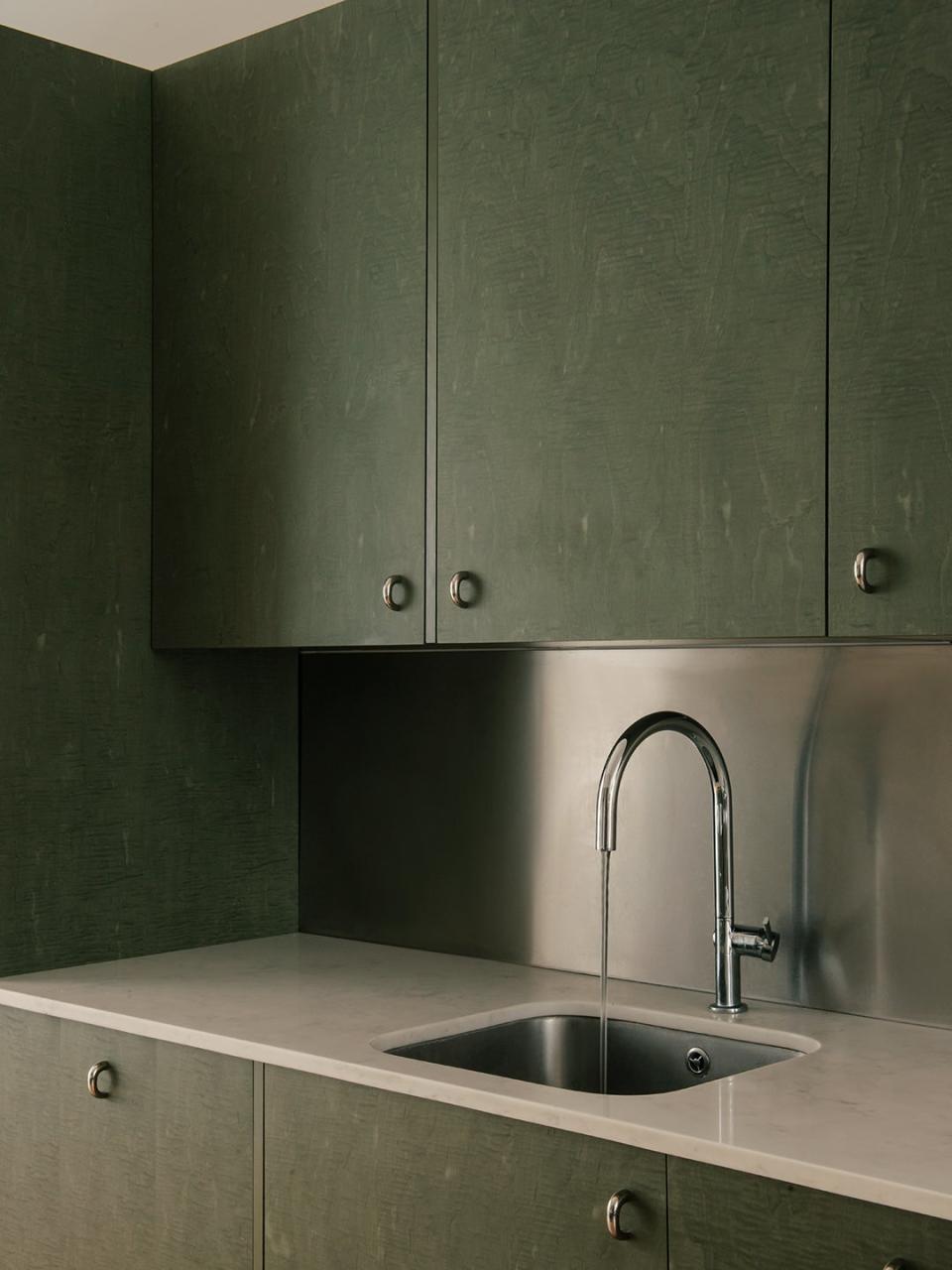 green cabients over sink