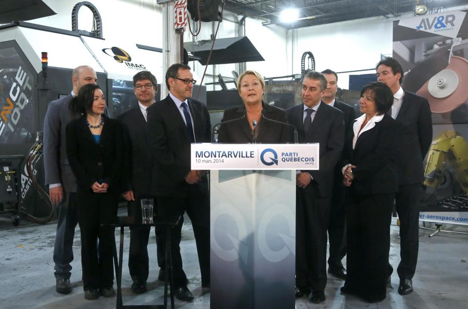 REFILE - CORRECTING TOWN Parti Quebecois leader Pauline Marois (C) introduces her economic team during a campaign stop in Saint-Bruno-de-Montarville, Quebec, March 10, 2014. Quebec voters will go to the polls in a provincial election April 7. REUTERS/Christinne Muschi (CANADA - Tags: POLITICS ELECTIONS)