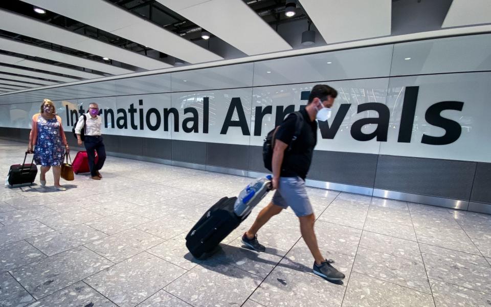 Passengers in the arrivals hall at Heathrow Airport, London - Aaron Chown/PA Wire