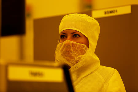 FILE PHOTO: A technician works at Israeli chipmaker TowerJazz's plant in Migdal HaEmek, northern Israel September 13, 2017. Picture taken September 13, 2017. REUTERS/Ronen Zvulun/File Photo