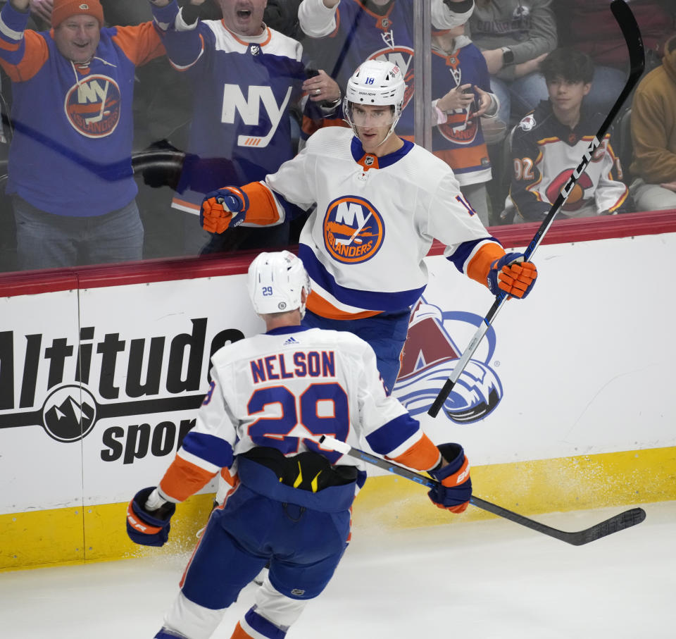 New York Islanders left wing Pierre Engvall, back, is congratulated by center Brock Nelson for a goal against the Colorado Avalanche during the first period of an NHL hockey game Tuesday, Jan. 2, 2024, in Denver. (AP Photo/David Zalubowski)