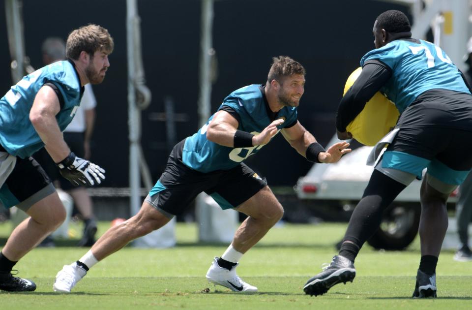 Jaguars (85) TE Tim Tebow and (72) OL Walker Little go up against (74) OL Cam Robinson during drills at Thursday's OTA session. The Jacksonville Jaguars held their Thursday session of organized team activity at the practice fields outside TIAA Bank Field, May 27, 2021. [Bob Self/Florida Times-Union]