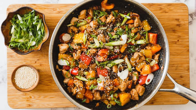 Chicken vegetables in skillet with green onions