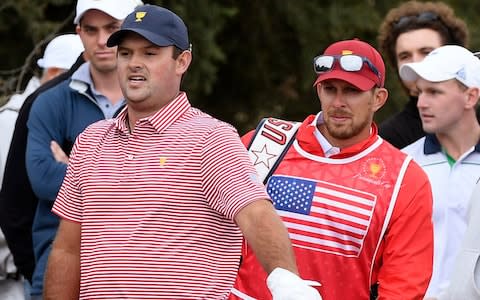  U.S. team player Patrick Reed and his caddie, Kessler Karain, - Credit: AP