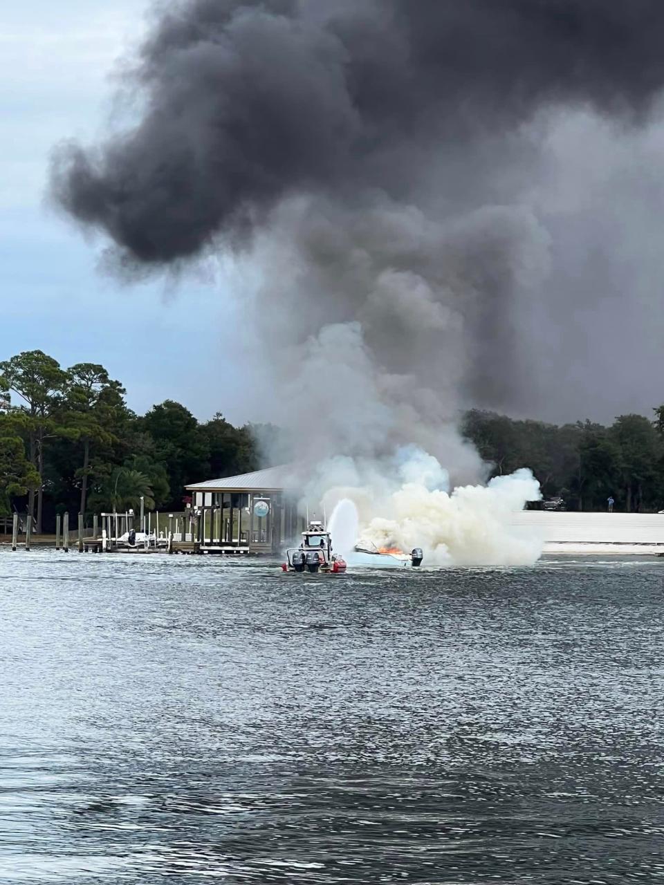 Destin firefighters put out a fire on a boat after an Okaloosa County deputy and Eglin police unit kept the boat away from a private dock using their wakes.