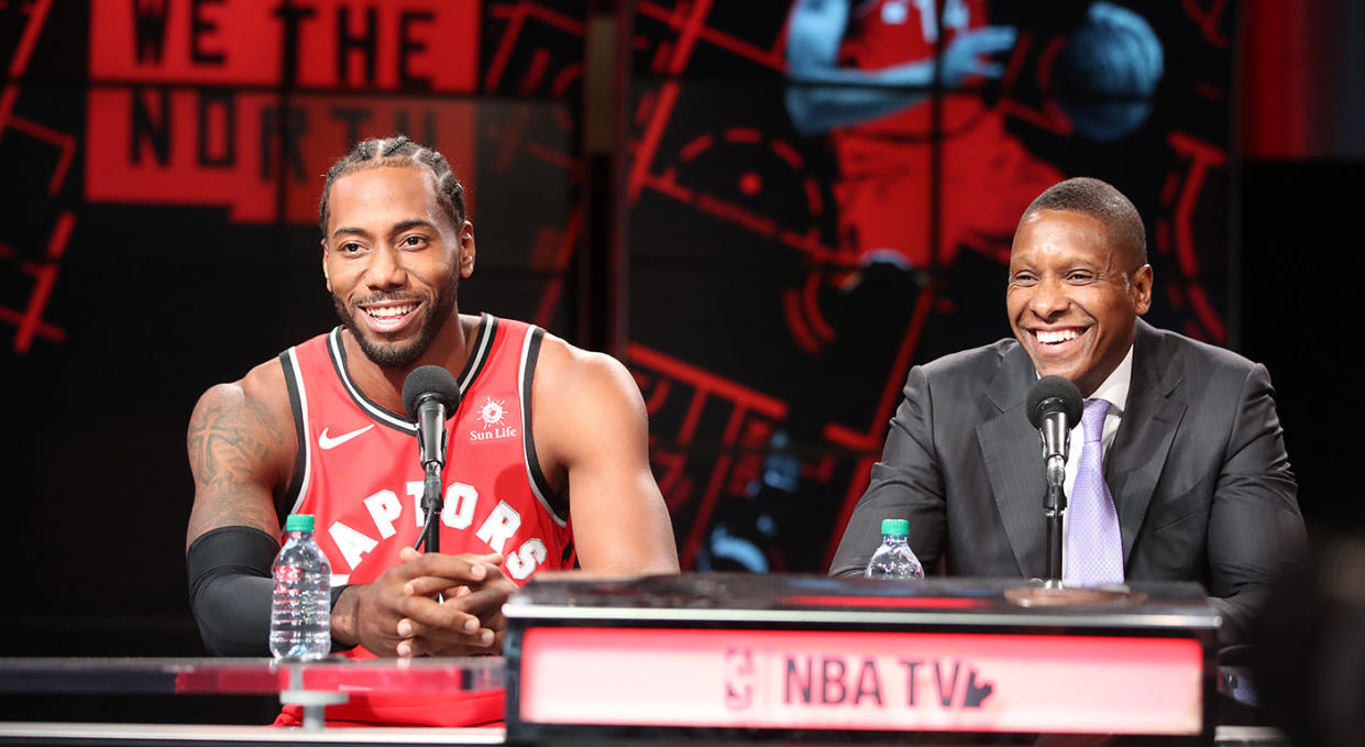 Leonard, left, and Ujiri share a laugh during a press conference. (Steve Russell/Toronto Star via Getty Images)