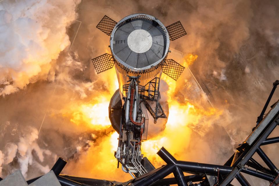 A SpaceX Starship Super Heavy booster is pictured on the launch pad during a test firing of its 33 Raptor engines ahead of a suborbital test launch attempt at the company's Texas development facility called Starbase.