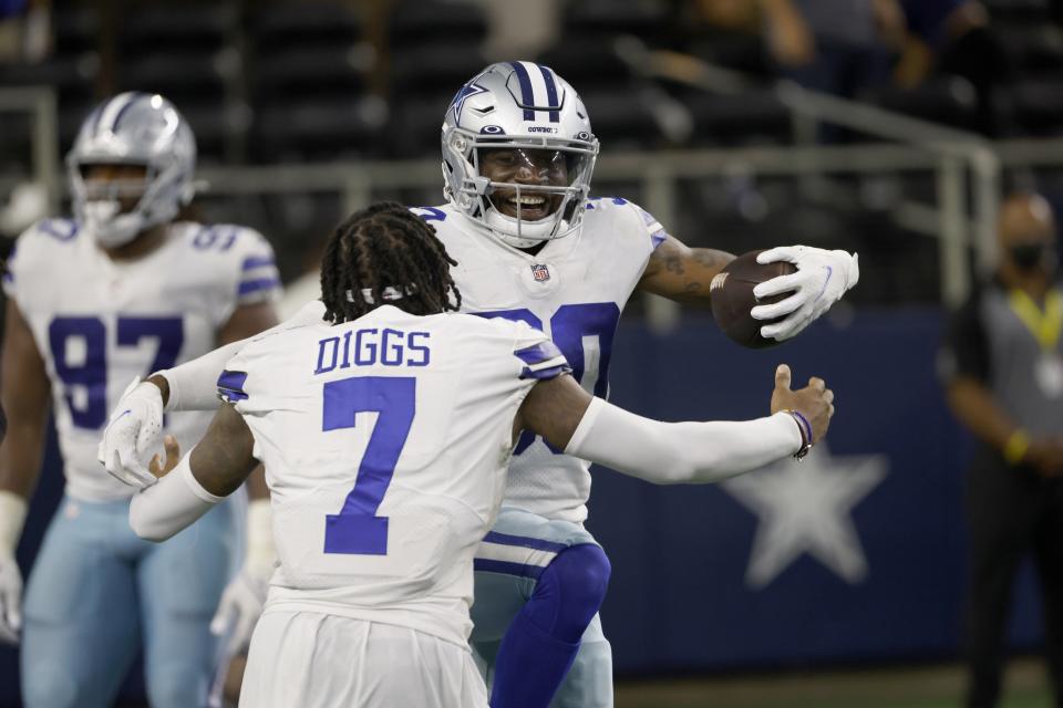 Dallas Cowboys cornerback Trevon Diggs (7) and cornerback Anthony Brown, rear, celebrate after Brown intercepted a New York Giants' Mike Glennon pass and returned it for a touchdown in the second half of an NFL football game in Arlington, Texas, Sunday, Oct. 10, 2021. (AP Photo/Ron Jenkins)