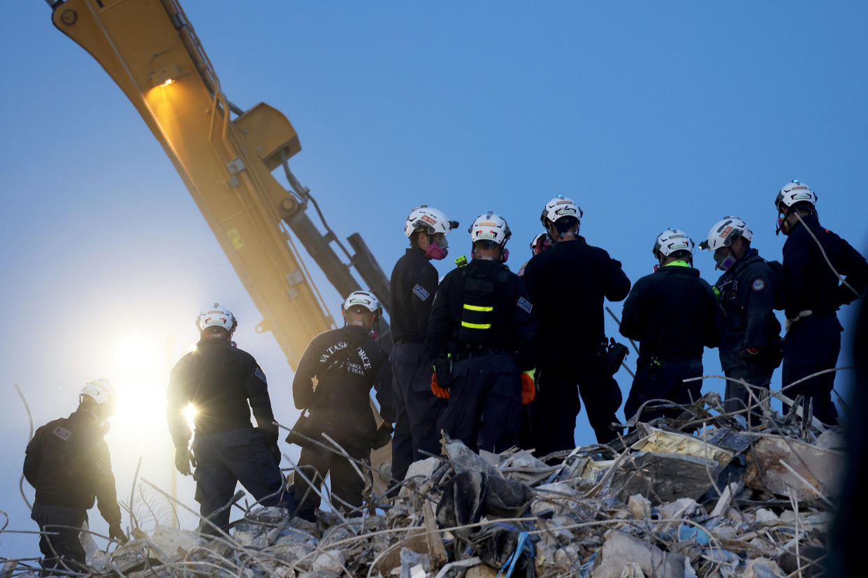 IMAGE: An excavator digs through the Champlain Towers South building Friday in Surfside, Fla. (Anna Moneymaker / Getty Images)