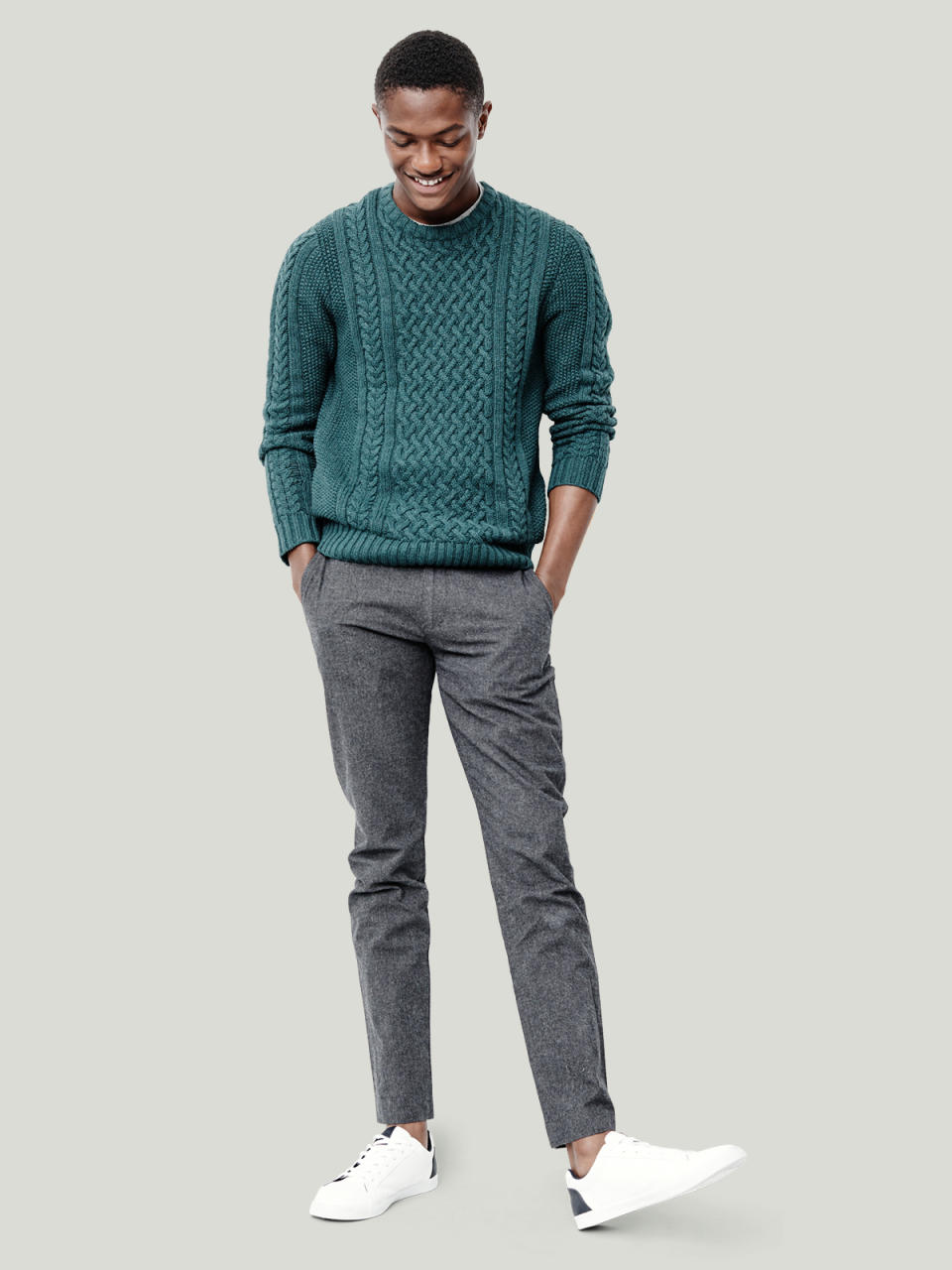 Cable-knit sweater and gray skinny trousers