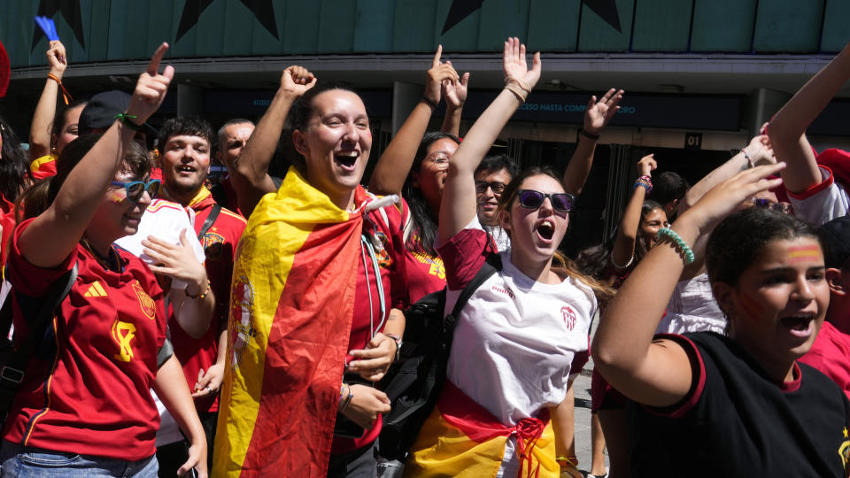 Spanish fans celebrate in a street, in Madrid, Spain, Sunday, Aug. 20, 2023, after Spain won against England in the Women's World Cup final soccer match played in Australia. (AP Photo/Paul White)