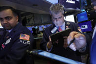 FILE - In this Feb. 5, 2020, file photo specialist Dilip Patel, left, and trader John Panin work on the floor of the New York Stock Exchange. The U.S. stock market opens at 9:30 a.m. EST on Thursday, Feb. 20. (AP Photo/Richard Drew, File)