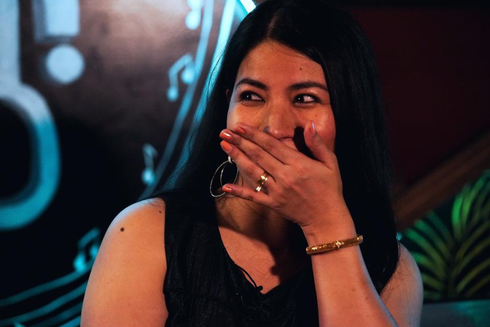 Filipina comedian Imah Dumagay reacts while speaking to The Associated Press before an open-mic night at the Hi Five Restaurant & Lounge in Dubai, United Arab Emirates, Sunday, Aug. 8, 2021. Dumagay's rapid-fire punchlines offer an unfiltered glimpse into the life, sly triumphs and slights faced by her 2.2 million compatriots working in the Middle East. They send billions of U.S. dollars in remittances back to their families still living in the Philippines, but live in countries that often treat them as a disposable, low-paid workforce. (AP Photo/Jon Gambrell)