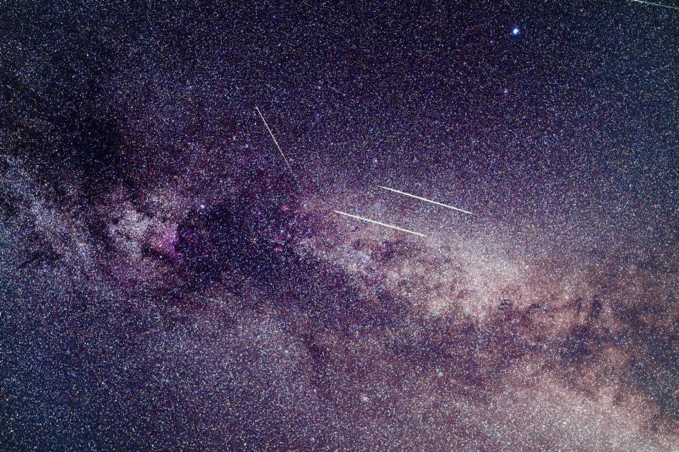 Perseid meteors visible over milky way background in region near Cygnus constellation