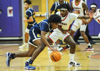 Colonia's Saivon Pressley (left) tries to get around St. Thomas Aquinas' Adam Silas in the GMC Tournament final on Friday, Feb. 25, 2022 at Monroe.