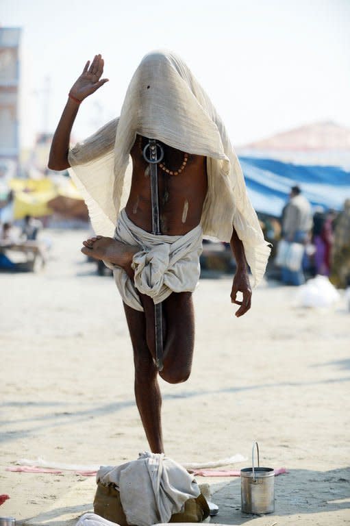 A Hindu holy man prays while standing on one leg at the banks of the River Ganges at the Kumbh Mela in Allahabad on February 9, 2013. Tens of millions of Hindu pilgrims are preparing to cleanse their sins with a plunge into the sacred River Ganges, ahead of the most auspicious day of the world's largest religious festival