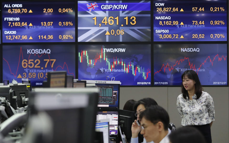 Currency traders watch monitors at the foreign exchange dealing room of the KEB Hana Bank headquarters in Seoul, South Korea, Tuesday, Oct. 22, 2019. Shares are gaining in Asia after upbeat comments from President Donald Trump and other U.S. officials on the status of trade negotiations with China. (AP Photo/Ahn Young-joon)