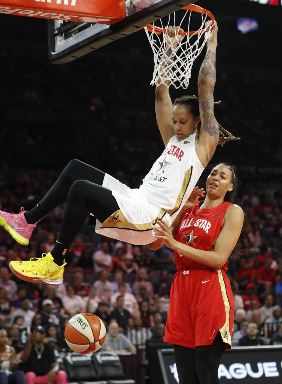 Phoenix Mercury's Brittney Griner, of Team Delle Donne, dunks over Las Vegas Aces' Liz Cambage, of Team Wilson, during the first half of a WNBA All-Star game Saturday, July 27, 2019, in Las Vegas. (AP Photo/John Locher)