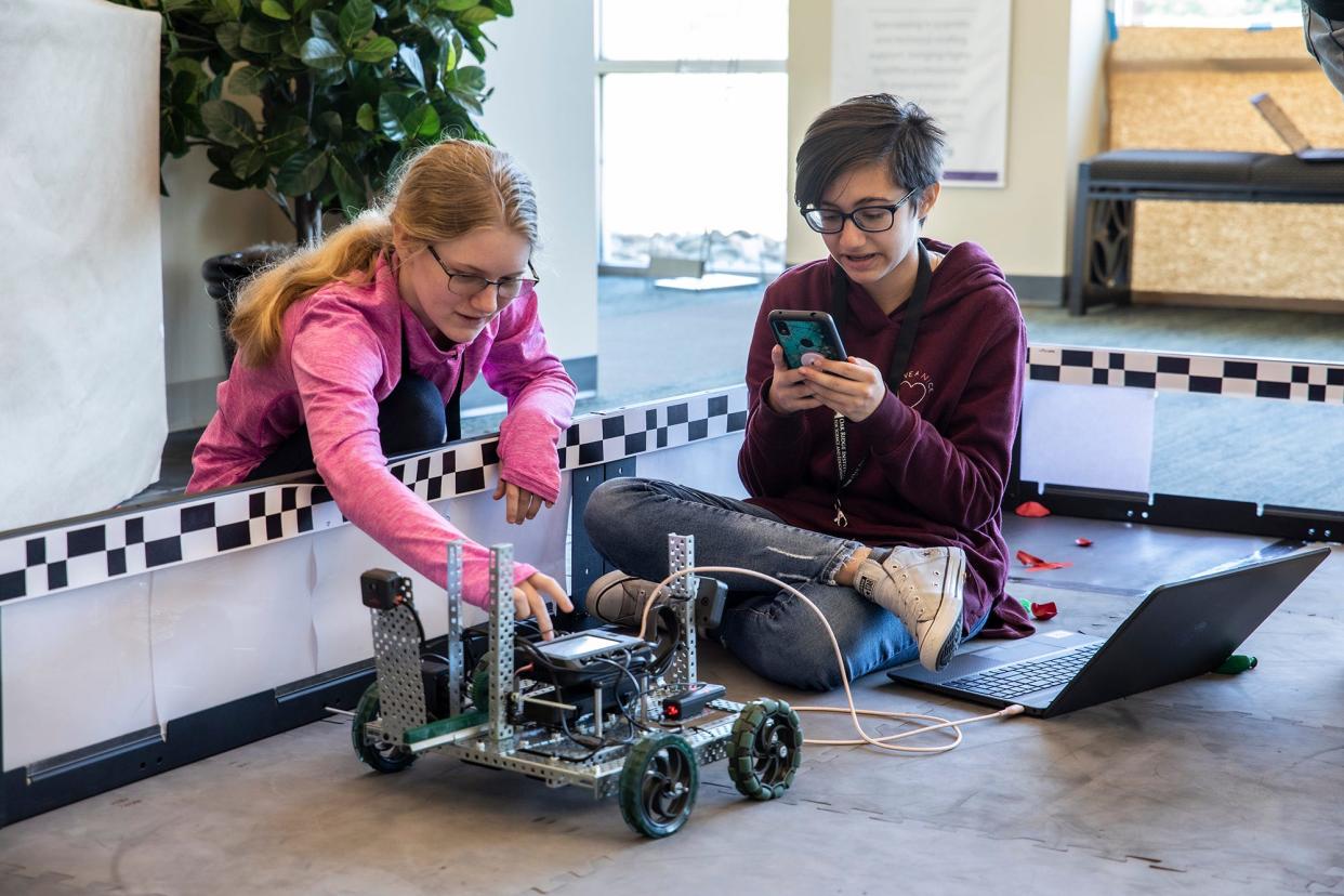 Ciara Matlock and Andrea Torres Nieves work together on programming their robot.