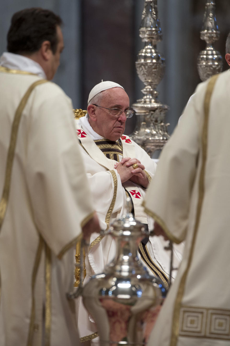 An amphora containing holy oil is brought before Pope Francis during the Chrism Mass in St. Peter's Basilica at the Vatican, Thursday, April 17, 2014. During the mass the Pontiff blesses a token amount of oil that will be used to administer the sacraments throughout the year. The Chrism Mass marks the start of the Easter celebrations. (AP Photo/Andrew Medichini)