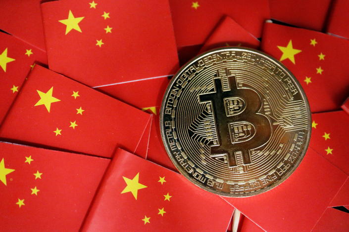 A representation of Bitcoin cryptocurrency is seen amid China&#39;s flags in this illustration picture taken September 27, 2021. REUTERS/Florence Lo/Illustration