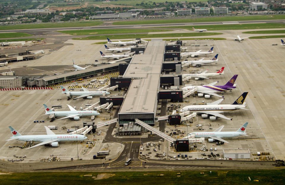 London, UK - May 30, 2016: Aerial view of aeroplanes standing at Terminal 2 of London Heathrow Airport on a cloudy day in May. Airlines using this terminal include Air Canada, Singapore Airlines and United Airlines.