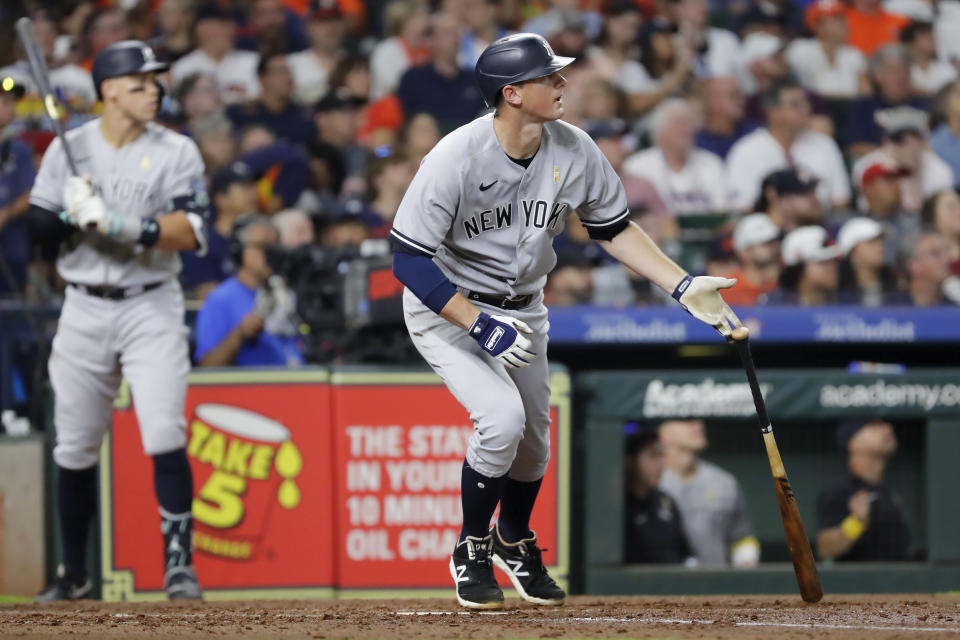 New York Yankees' DJ LeMahieu, right, flips his bat as he watches his one-run RBI double along with Aaron Judge, left, against the Houston Astros during the sixth inning of a baseball game Sunday, {monthname4}. 3, 2023, in Houston. (AP Photo/Michael Wyke)