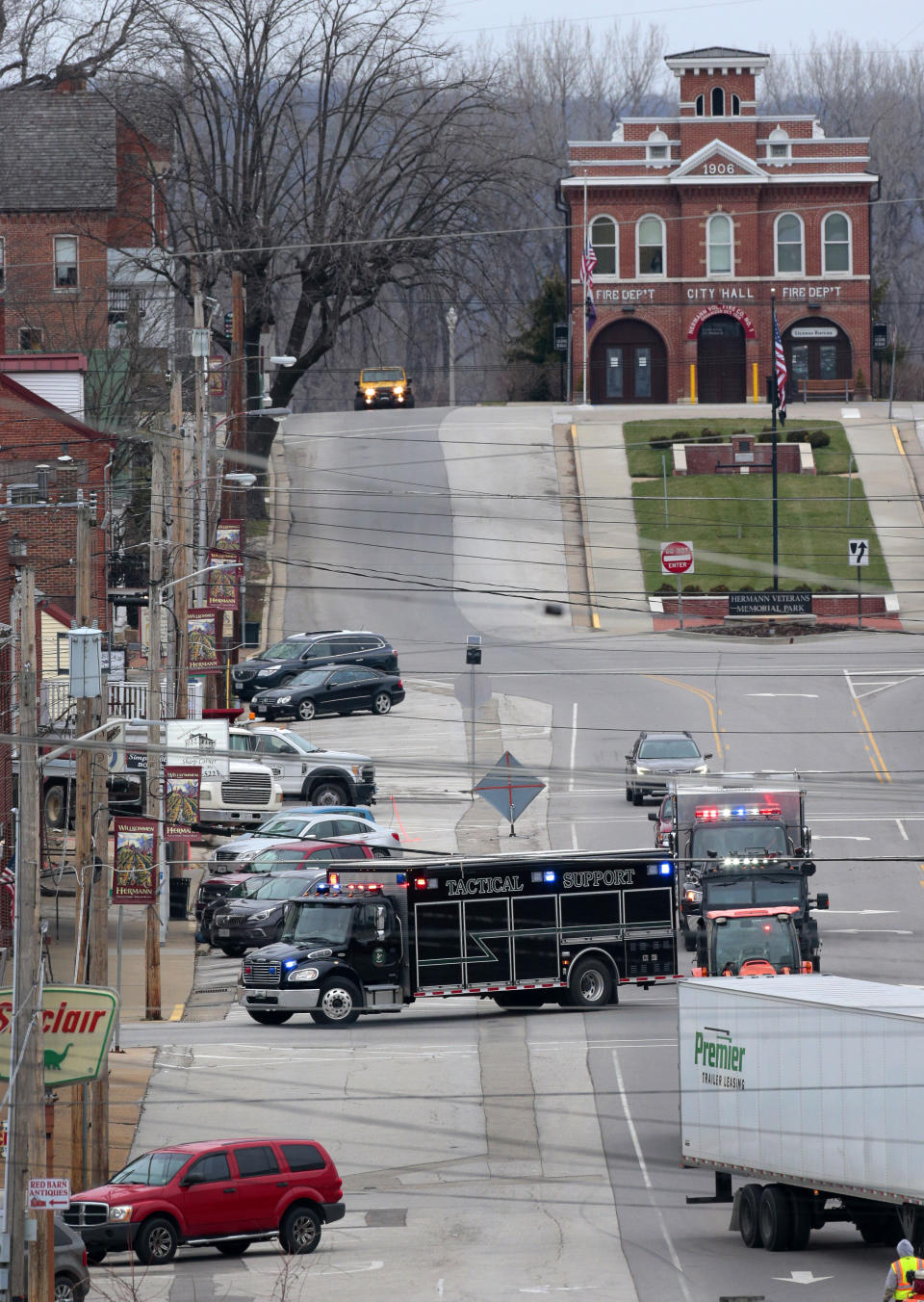 Tactical units from St. Charles County arrive in downtown Hermann, Mo., Monday, March 13, 2023, to help with the investigation after two Hermann police officers were shot Sunday, and one later died. (Robert Cohen/St. Louis Post-Dispatch via AP)