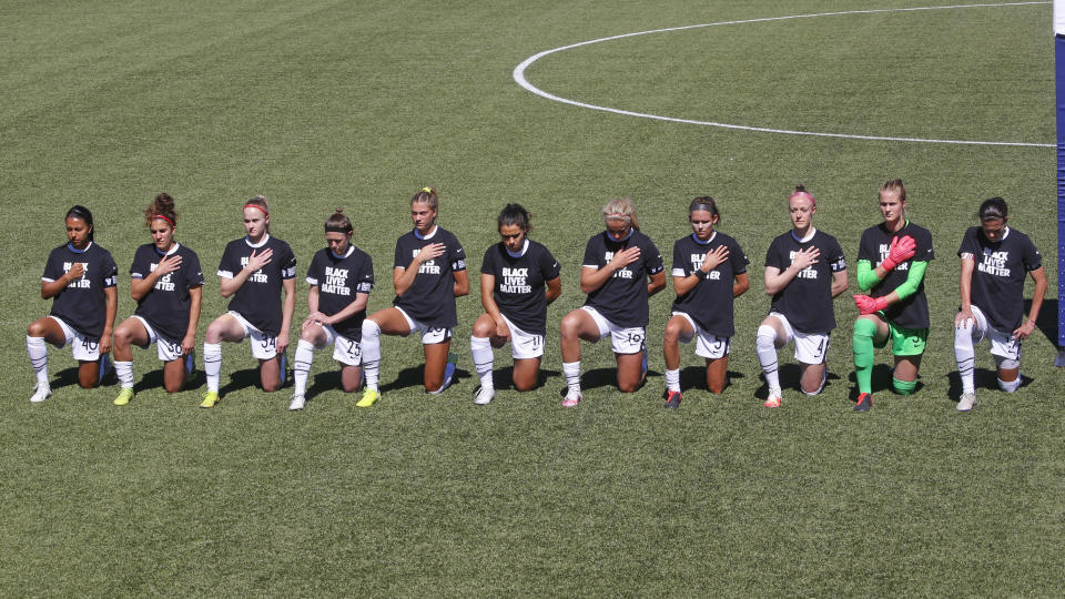 Players for the Portland Thorns kneel during the national anthem before the start of their NWSL Challenge Cup soccer match against the North Carolina Courage at Zions Bank Stadium Saturday, June 27, 2020, in Herriman, Utah. (AP Photo/Rick Bowmer)