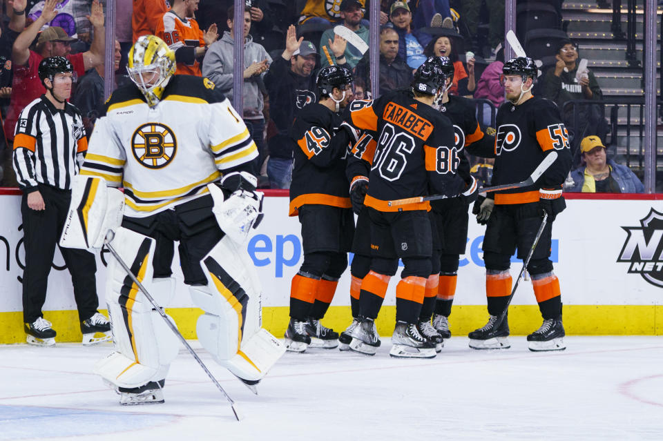 Philadelphia Flyers celebrates the goal by Owen Tippett, third from left, as Boston Bruins' Jeremy Swayman skates away during the third period of an NHL hockey game, Sunday, April 9, 2023, in Philadelphia. The Bruins won 5-3.(AP Photo/Chris Szagola)