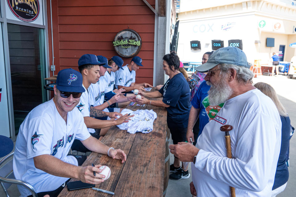 Blue Wahoos players sign autographs for season-ticket holders during special pregame event Sunday