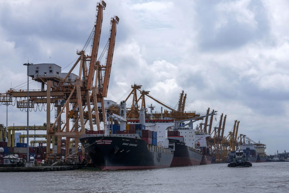 FILE - Containers on ships are unloaded at Bangkok Port in Bangkok, Thailand. Friday, Oct. 15, 2021. Economies in the Asia-Pacific are forecast to slow sharply this year as decades-high inflation and the war in Ukraine compound geopolitical uncertainties and the aftereffects of the pandemic. (AP Photo/Sakchai Lalit, File)