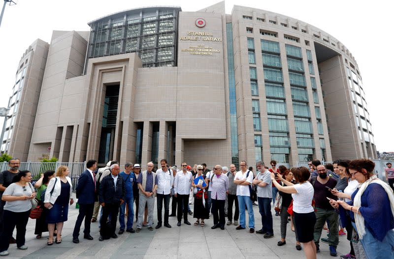 FILE PHOTO: Mater, Balikci, Turker and Eryilmaz, who were guest editors at pro-Kurdish daily Ozgur Gundem, are pictured with their fellow journalists before they appear at a court for testimony, outside the Justice Palace in Istanbul