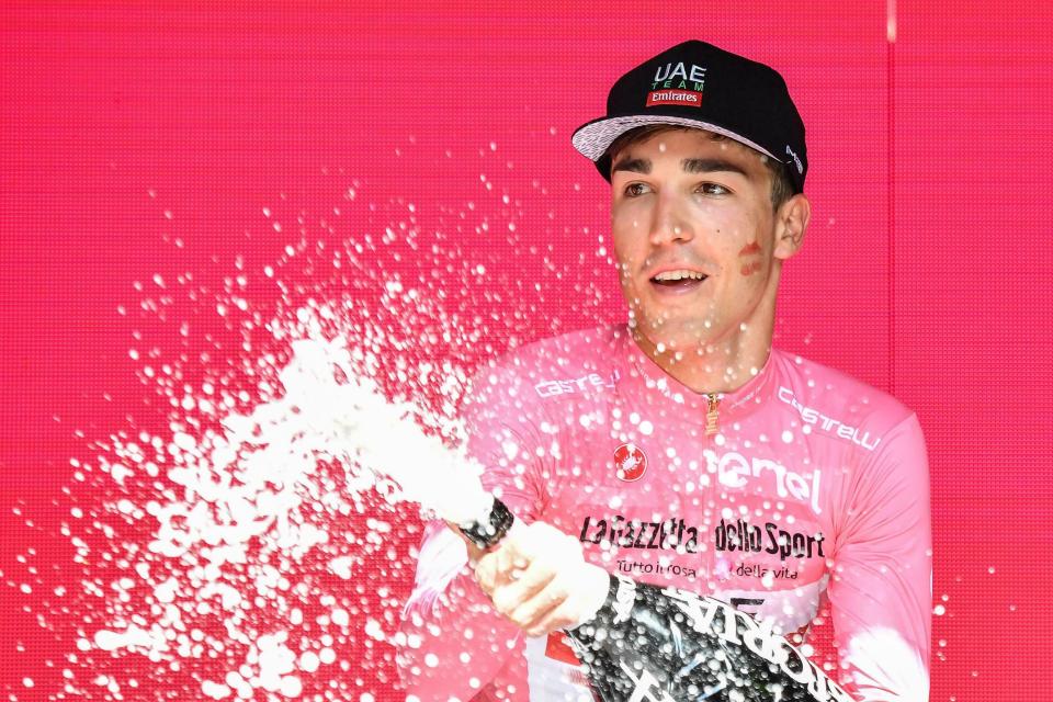 Italy's Valerio Conti celebrates on the podium after retaining the pink jersey of leader of the race in the seventh stage of the Giro d'Italia cycling race, from Vasto to L'Aquila, Italy, Friday, May 17, 2019. (Alessandro Di Meo/ANSA via AP)