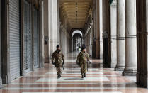 Italian soldiers patrol downtown Milan, Italy, Sunday, March 22, 2020. Italian Premier Giuseppe Conte has told the nation he is tightening the lockdown to fight the rampaging spread of coronavirus, shuttind down all production facilities except those that are "necessary, crucial, indispensible to guarantee" the good of the country. For most people, the new coronavirus causes only mild or moderate symptoms. For some it can cause more severe illness, especially in older adults and people with existing health problems. (AP Photo/Antonio Calanni)