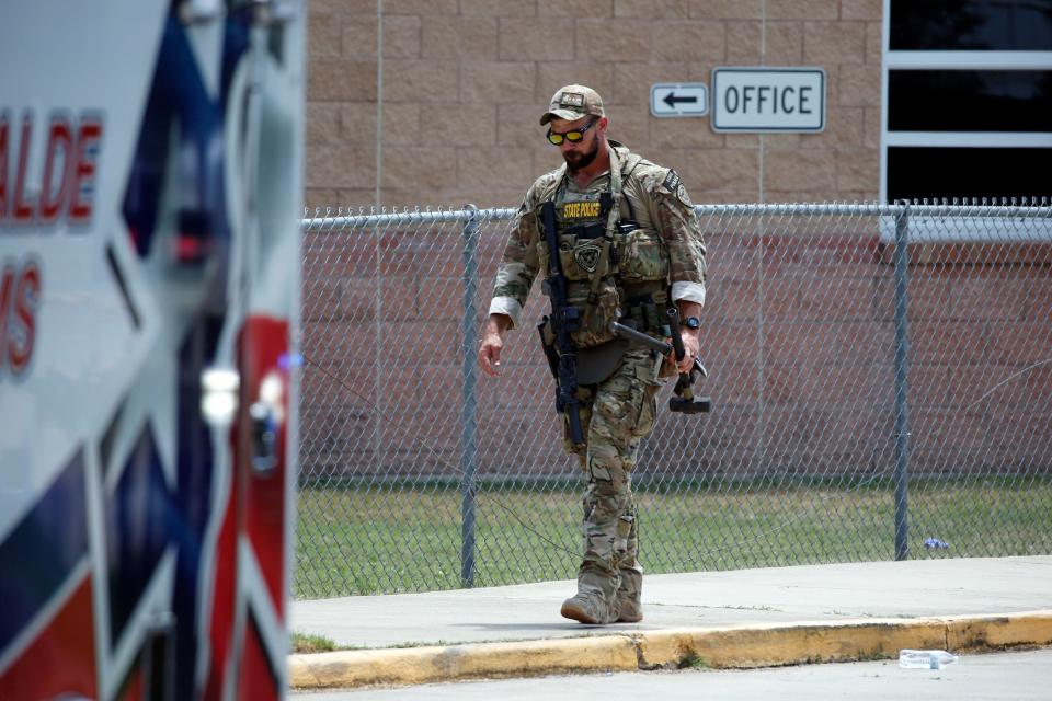 A Texas State Police officer walks outside Robb Elementary School following a shooting, Tuesday, May 24, 2022, in Uvalde, Texas.