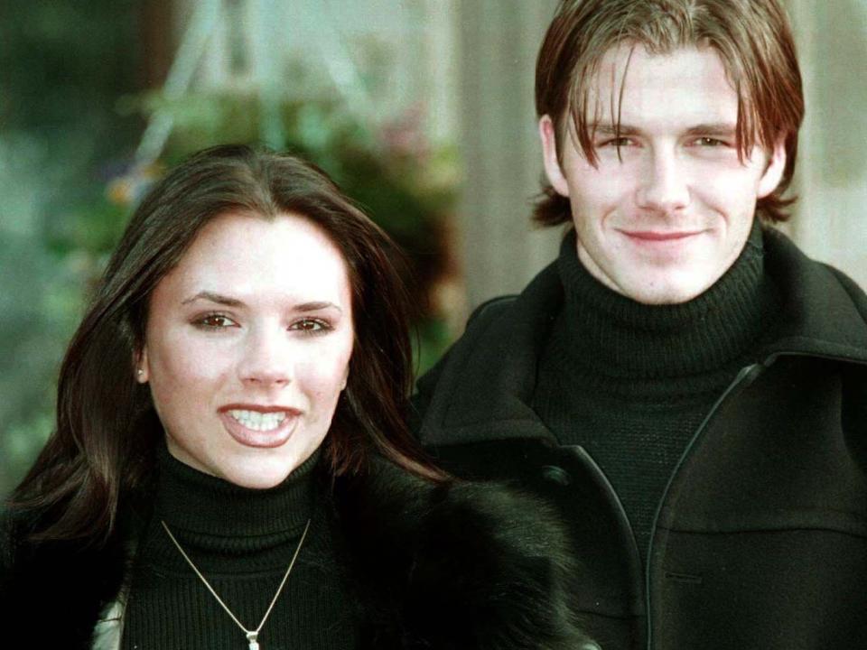 Victoria and David Beckham posing for photos after announcing their engagement in 1998 during a press conference